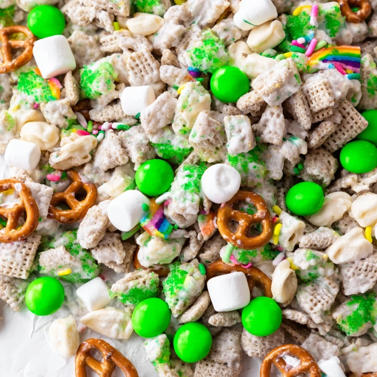 Festive St. Patricks Day Leprechaun Bait featuring white chocolate coated cereal and pretzel clusters
