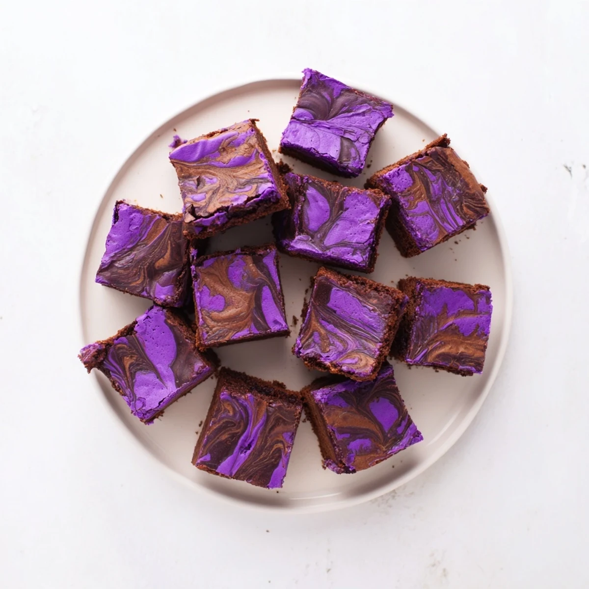 Glossy Filipino-style ube brownies topped with chocolate swirl and sliced into squares