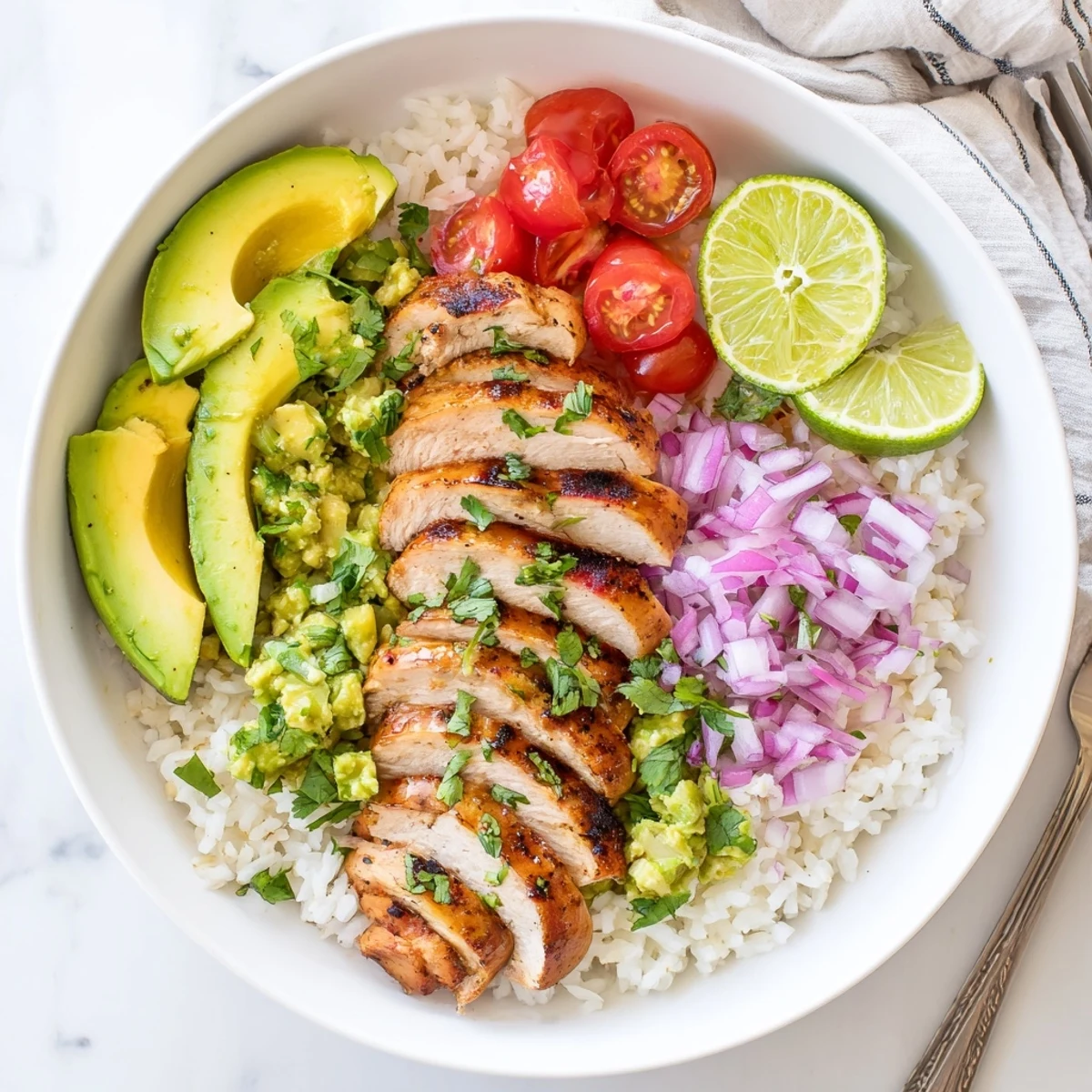 Vibrant layered Honey Lime Chicken Avocado Rice Stack showing tender marinated chicken, bright green avocado, and red onion on a white plate