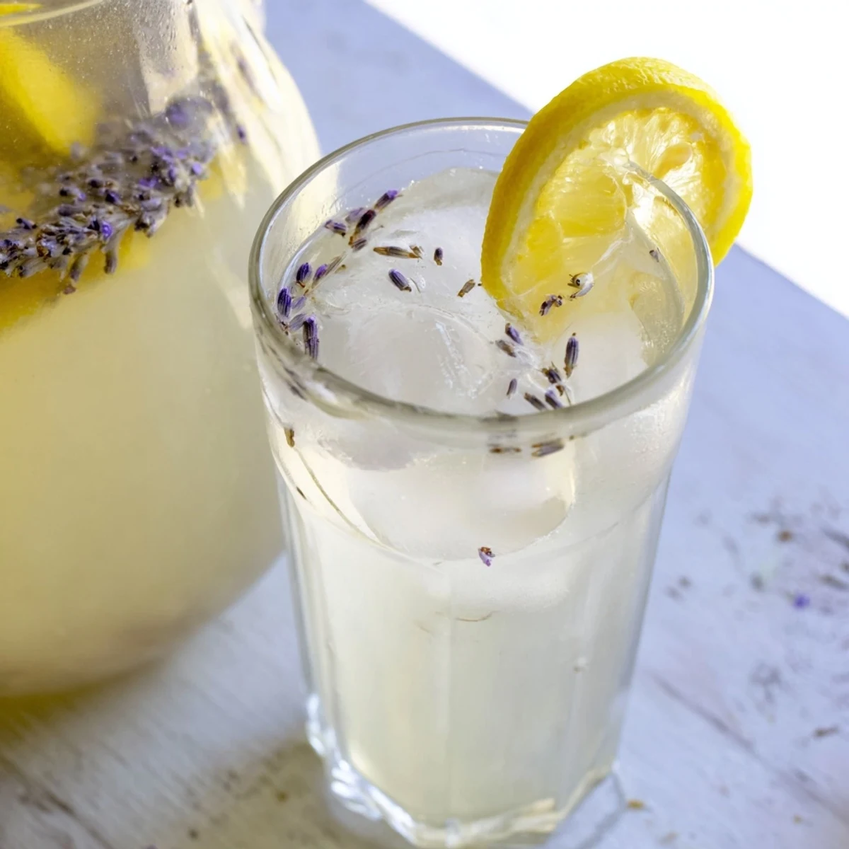 Golden lemonade infused with floral lavender syrup served over ice in a mason jar