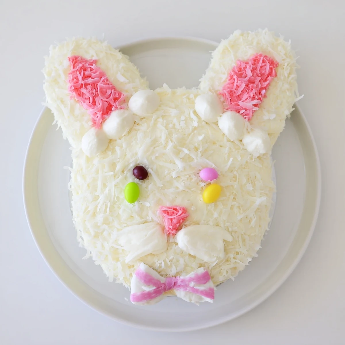 Festive bunny cake decorated with sweet coconut fur and pink fondant ears