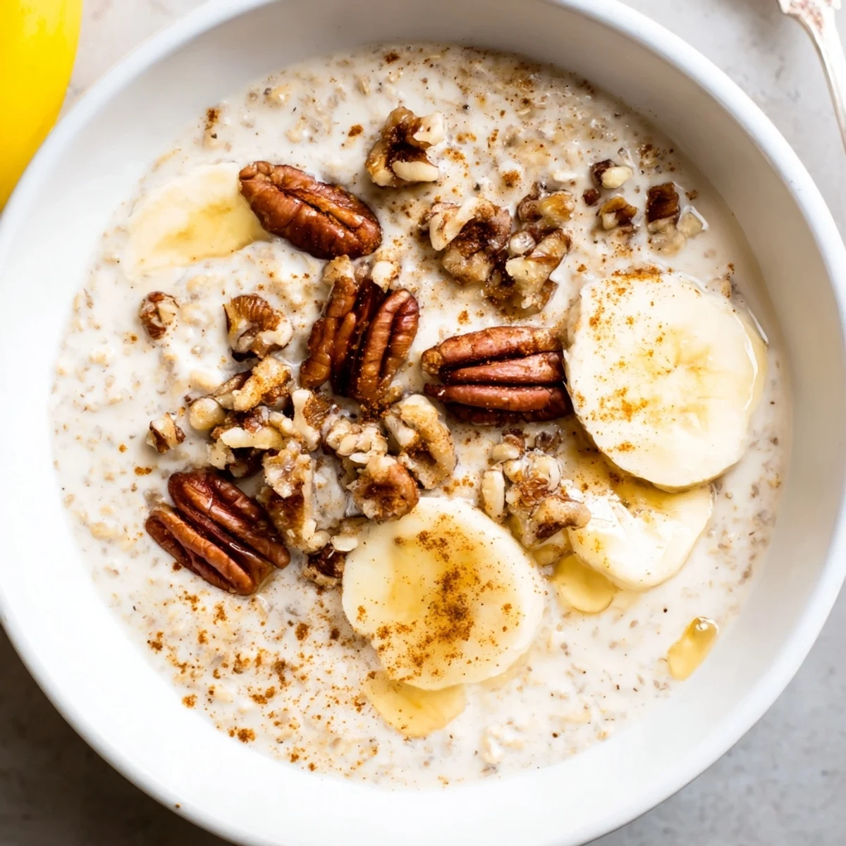 Maple cinnamon pecan overnight oats served in a glass jar with a sprinkle of warm spice and toasted pecan pieces
