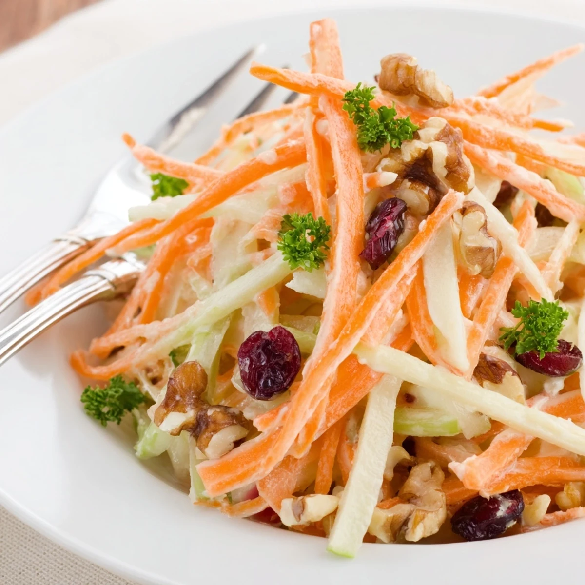 Crunchy Apple Carrot Salad With Creamy Citrus Dressing served chilled beside grilled salmon