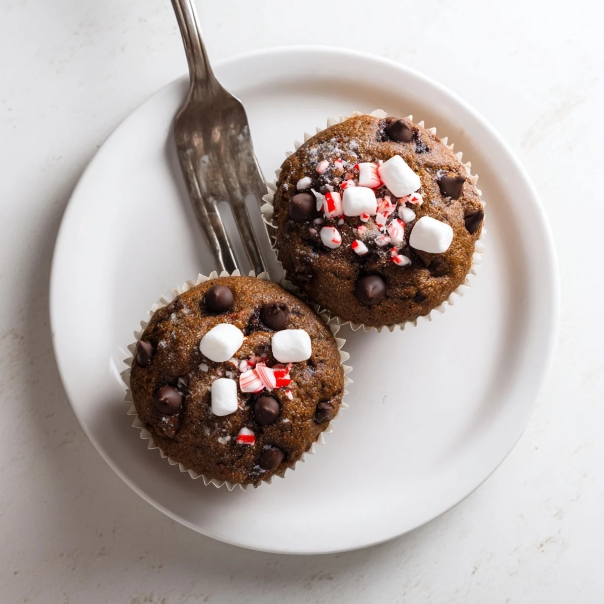 Peppermint Hot Chocolate Muffins cooling on wire rack, melted chips gleaming.