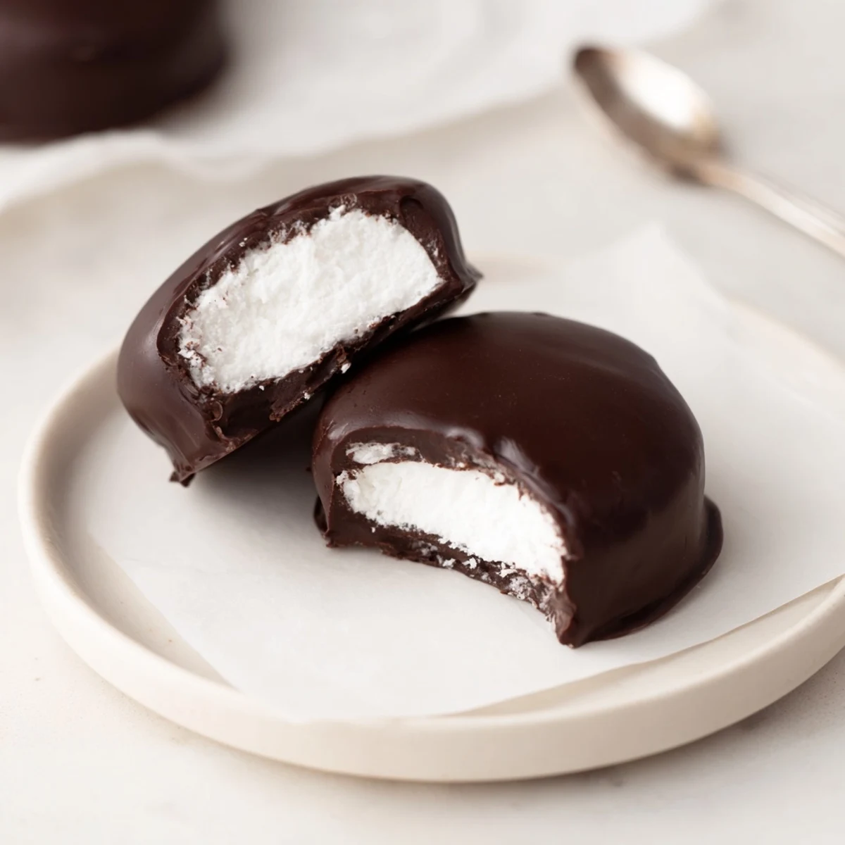 Homemade Peppermint Patties revealing creamy mint center, perfect after-dinner treat