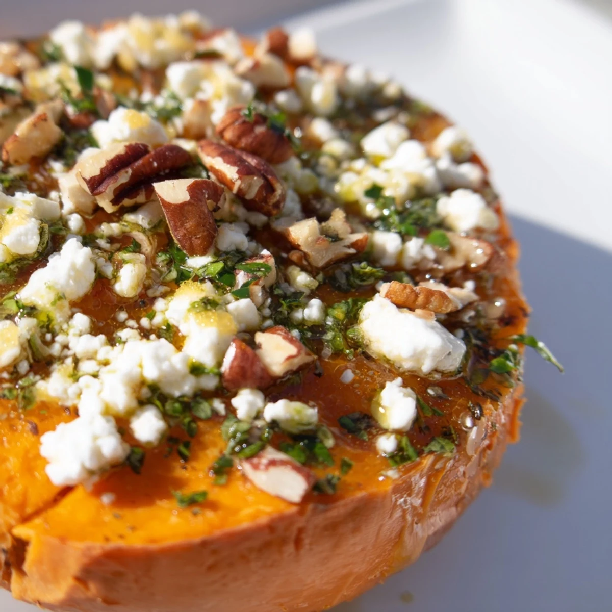 Appetizer platter featuring sweet potato crostini with creamy feta, honey, and fresh herb garnish