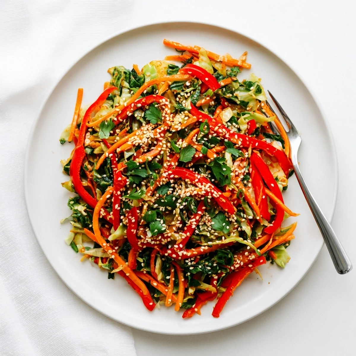 Steaming bowl of cabbage stir fry recipe with vibrant bell peppers and carrots