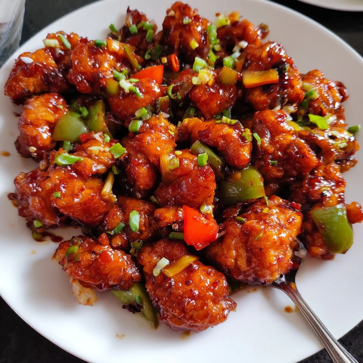 Fragrant wok-tossed Flavorful Chilli Chicken Indo Chinese with crisp peppers, scallions