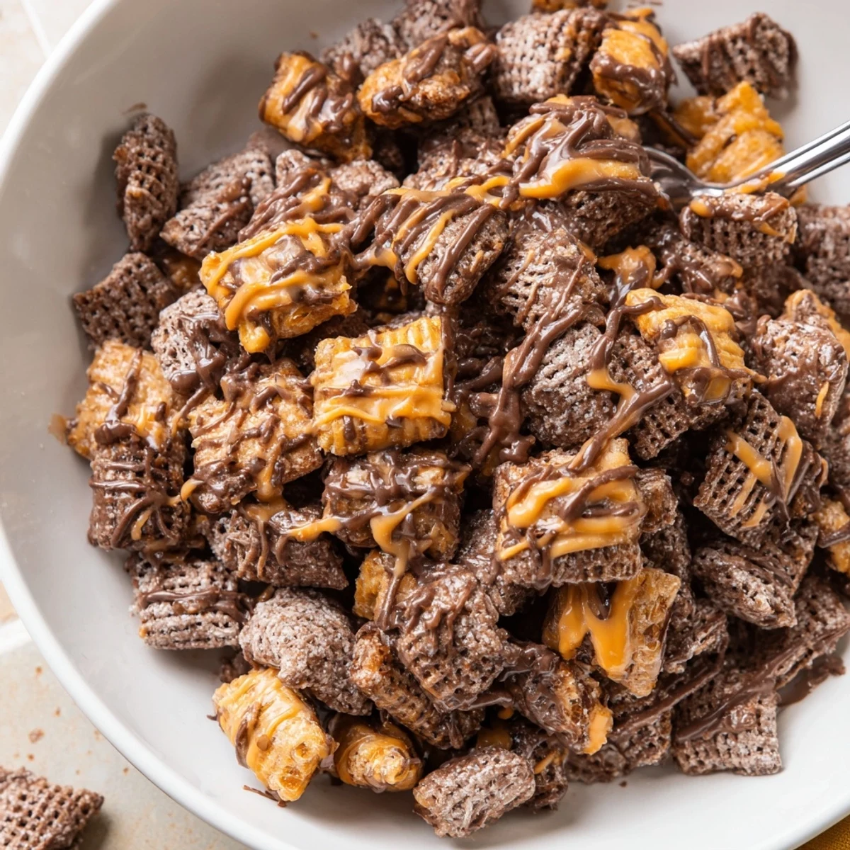 Sweet Samoas Puppy Chow Cereal tossed in powdered sugar, warm caramel ribbons
