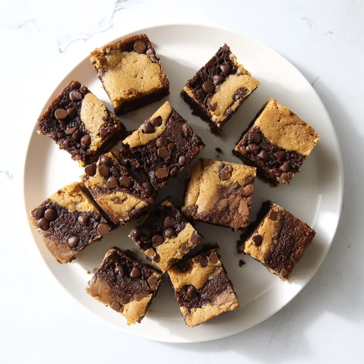 Freshly baked fudgy chewy brookies with cracked chocolate chip cookie tops and rich dark brownie bottoms
