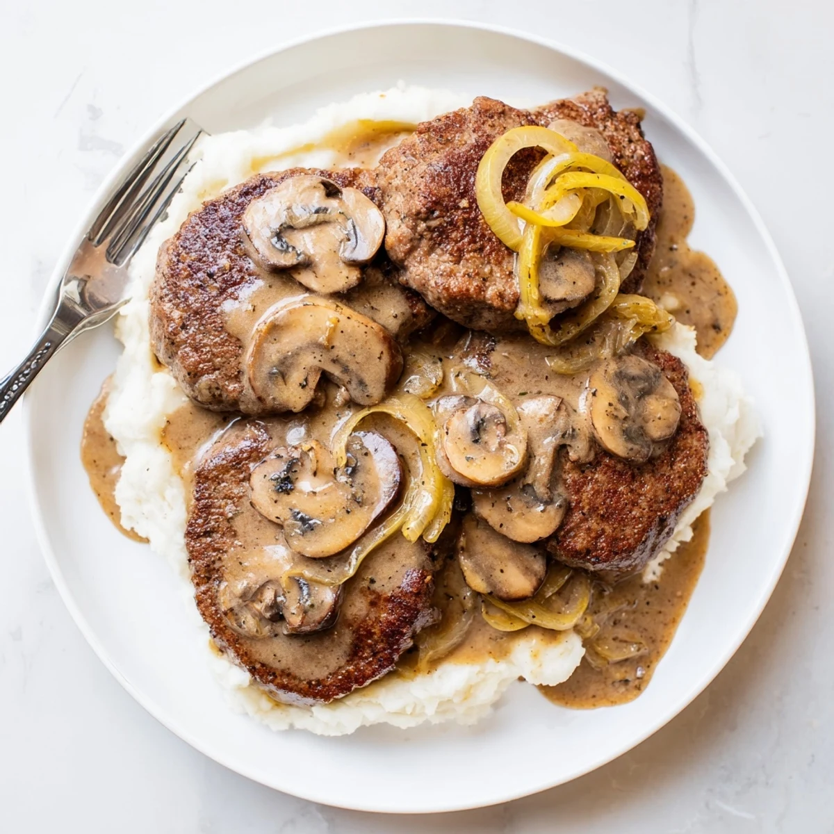 Homestyle Country Style Smothered Cube Steak simmered in rich gravy, fork-ready