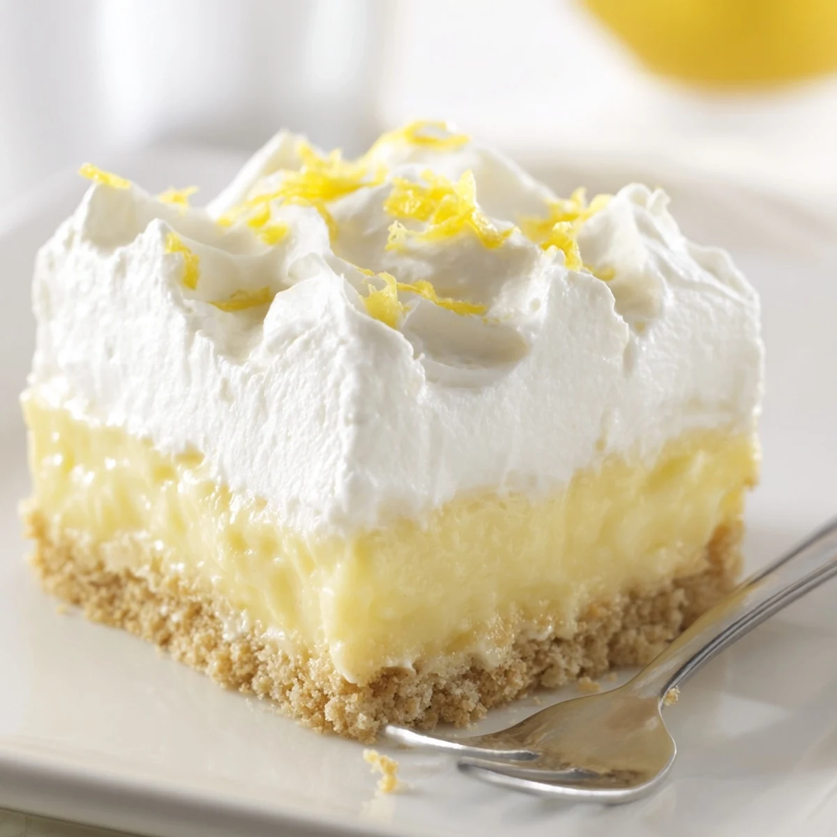 Homestyle Lemon Lush Cake on platter, crisp cookie crust and lemony filling.